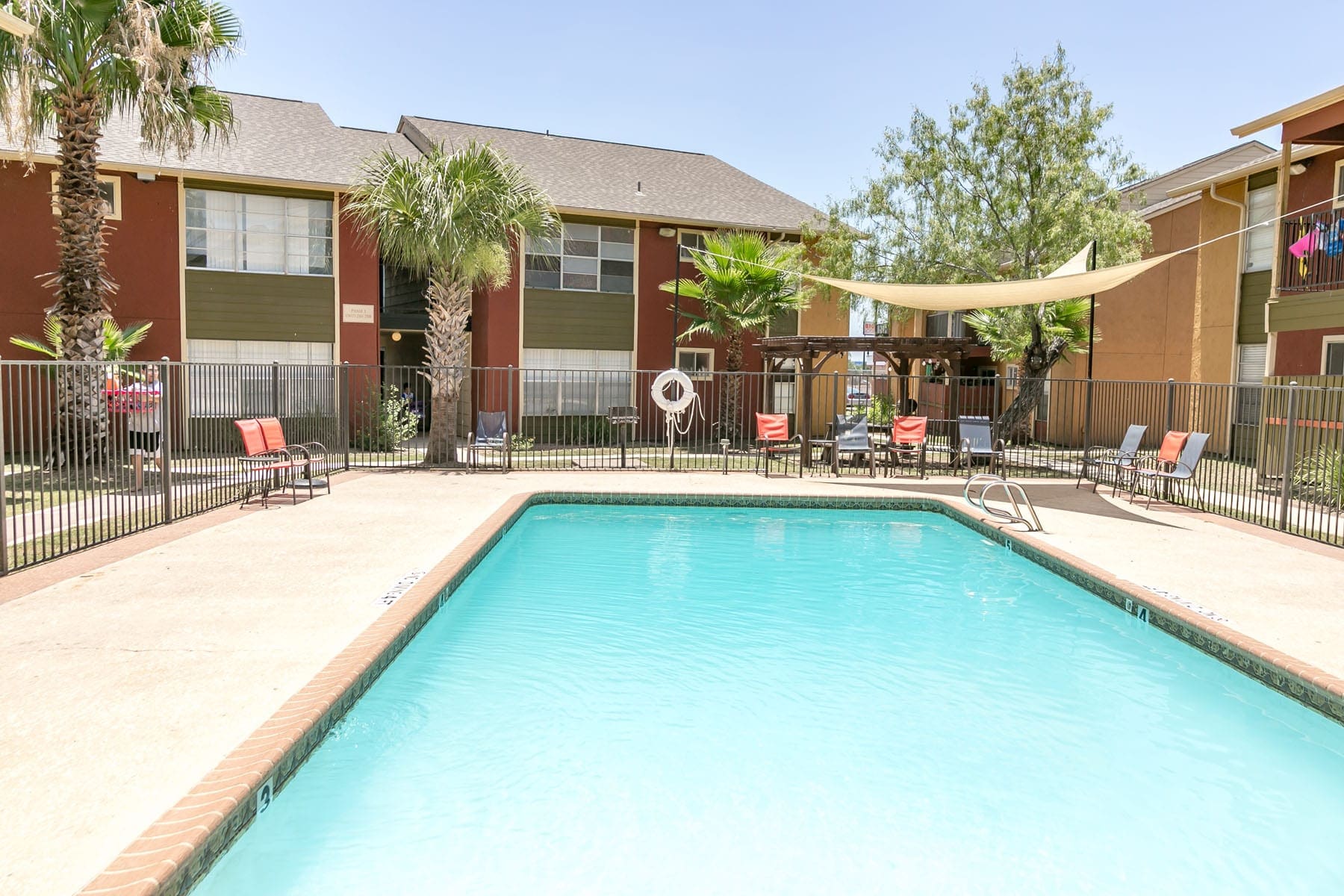 Apartments for Rent San Antonio - City-Base Vista - Outdoor Swimming Pool With Cool Water, Chairs, and a Covering in the Corner for Shade