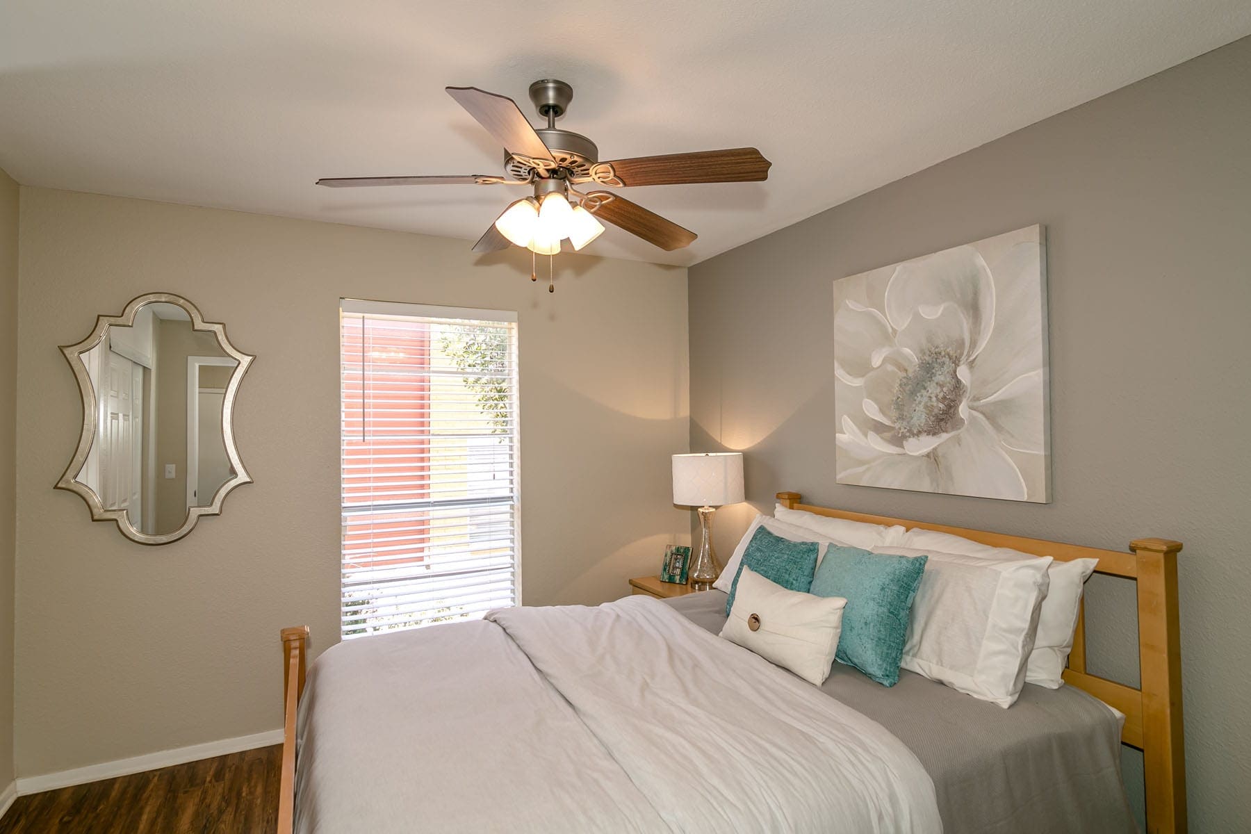Two Bedroom Apartments in San Antonio, TX - City-Base Vista Bedroom with Wood-Style Plank Flooring and Cooling Ceiling Fan
