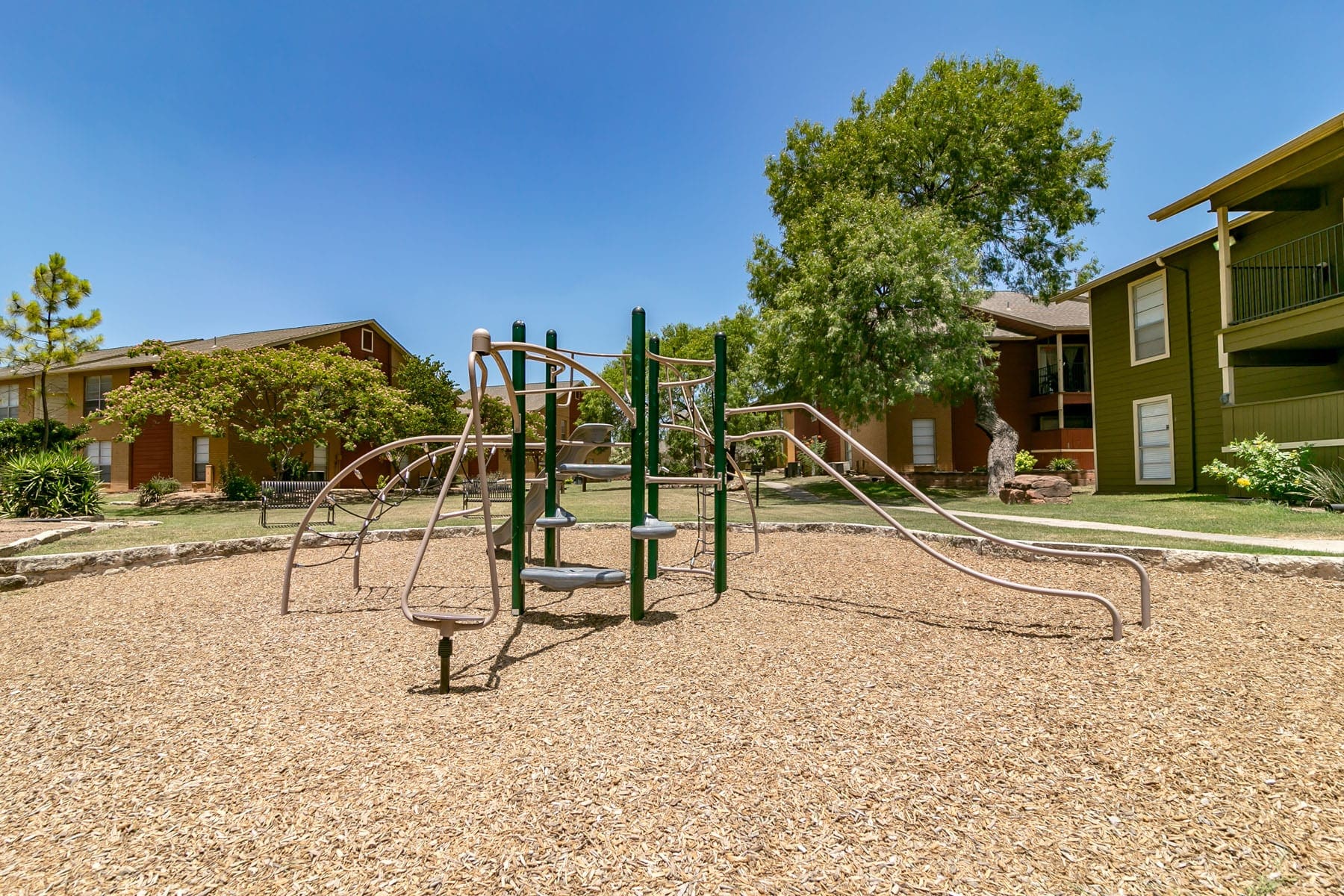 San Antonio TX Apartments for Rent - City-Base Vista - Resident Playground With a Bench, Steps, Slides, and Other Interactive Equipment